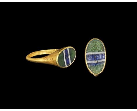  1st century BC-2nd century AD. A D-section gold hoop rising to an elliptical bezel with mosaic glass insert banded green, wh
