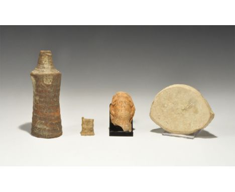  1st-4th century AD. A mixed group of artefacts comprising: a ceramic creamware pot base with old label 'From the ruins of Ca