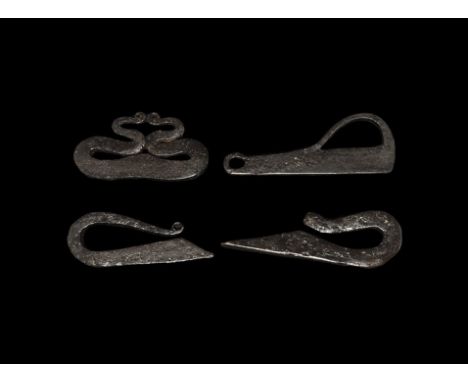  9th-13th century AD. A mixed group of iron firesteels comprising: one rectangular-section with scooped edge, recurved neck a