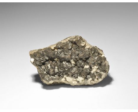  . An unusual specimen of sphalerite crystals forming a crust on both sides of a 1cm layer of quartz, with accessory white an