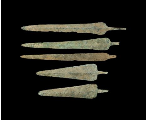  2nd millennium BC. A mixed group of lentoid-section bronze blades, two with broad straight shoulders and three with rounded 