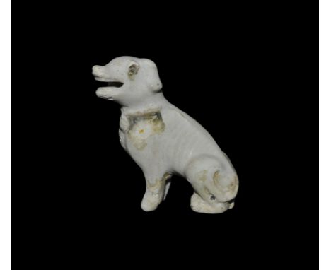  18th century AD. A glazed porcelain figure of a dog sitting on its haunches with open mouth; applied enamel(?) eyes. 45 gram