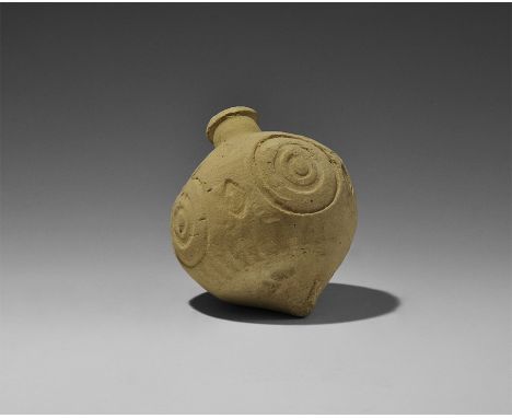  9th-11th century AD. A hollow ceramic piriform vessel with domed top and conical base; stamped concentric circles and lozeng