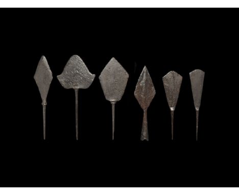  10th-14th century AD. A mixed group of iron arrowheads comprising: two tanged with bolster and chisel-shaped blade; two tang