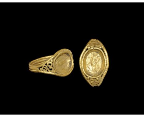  3rd century AD. A flat-section hoop of three bands, the outer two beaded, expanding shoulders with volute scrolled filigree 