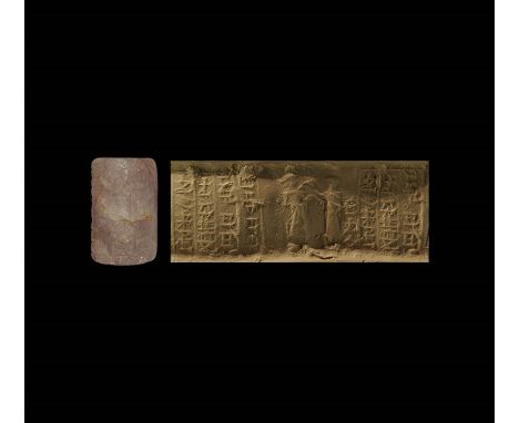  19th-16th century BC. A carved amethyst cylinder seal with figural frieze and owner's inscription; accompanied by a museum-q