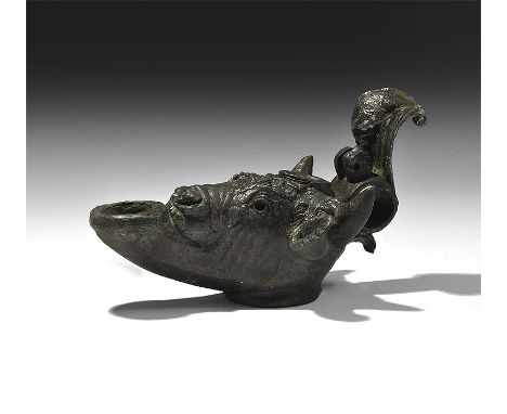  2nd century AD. A bronze lamp in the form of a bull's head, with short curved horns and hairy ears, large nose and round eye