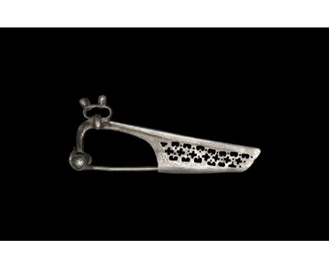  1st century AD. A silver flügelfibel bow brooch with with D-section bow and annular insert with four knops to the outer face