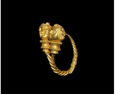  5th-3rd century BC. A gold earring with tapering twisted four-rod hoop and ribbed eye; the finial two reel-shaped collars wi