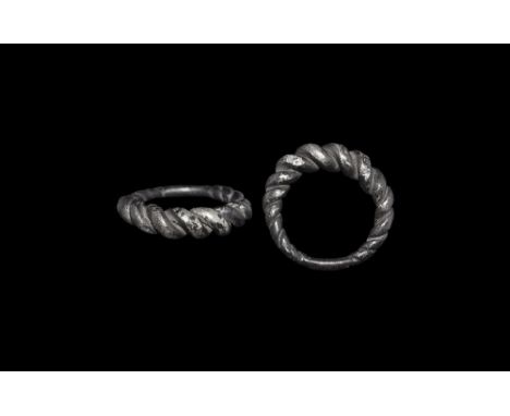  9th-11th century AD. A round-section silver hoop formed as two expanding rods twisted about each other, conjoined to the und