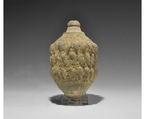  9th-11th century AD. A hollow-formed onion-shaped ceramic vessel with raised dome and central hole to the top, bands of vert