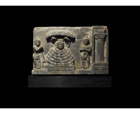  2nd-4th century AD. A rectangular carved schist frieze depicting Buddha wrapped in the coils of the Serpent King, Mucilinda,