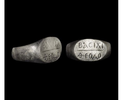  3rd-4th century AD. A broad flat-section silver hoop with flared shoulders, discoid plaque with inscription '??CI?? / ?????'
