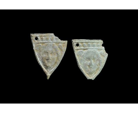  9th-12th century AD. A matched pair of ceramic plaques, each heater-shaped with band of raised pellets to the upper edge abo
