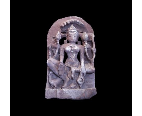  10th-12th century AD. A relief panel carving of a Tantric goddess seated on a throne with a seven headed cobra rearing over 