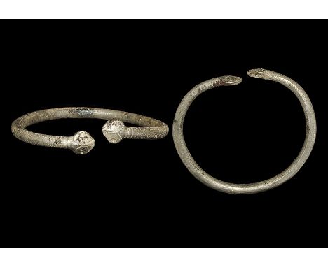  1st-2nd century AD. A silver armilla bracelet, round in section with punched-point and stamped herringbone detail, each fini