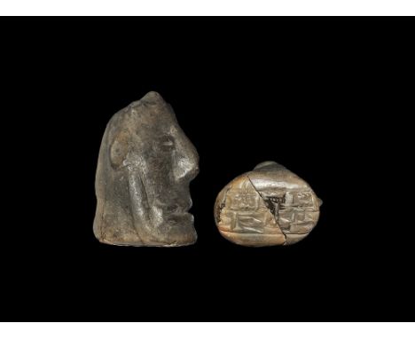 3rd millennium BC. A ceramic male head with three-spiked hairstyle, panel of cuneiform script to the underside. 96 grams, 64