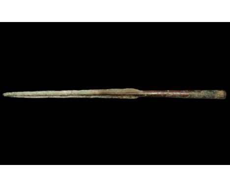  2nd millennium BC. A slender tapering Bronze Age blade with sturdy midrib developing to a narrow tapering socket. 138 grams,