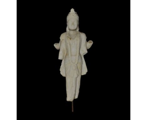  18th century AD. A white marble figure of the Hindu god Vishnu standing and wearing a dhoti with wide sash, garland and neck