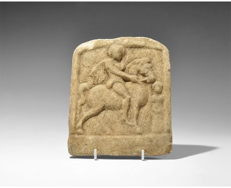  2nd-3rd century AD. A D-shaped marble stele with scene in high relief of a horseman on a galloping horse, short cloak over h