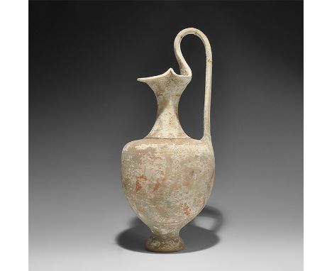  3rd century BC. A broad ceramic oinochoe with pedestal foot, ribbed strap handle and trefoil lip; the shoulder with running 