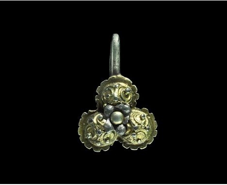  16th century AD. A silver-gilt clothes fastener formed as a trilobe plaque with notched border and three hemispherical domes