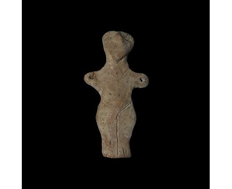  Neolithic, 6th-5th millennium BC. A ceramic standing figure with a triangular face and arms extended and pierced, possibly f