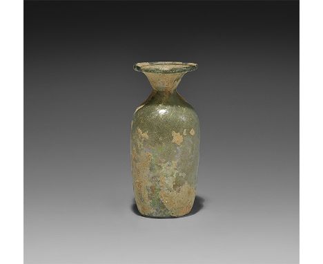  3rd-4th century AD. A cylindrical glass bottle with concave base, steep shoulder, narrow neck and flared mouth with applied 