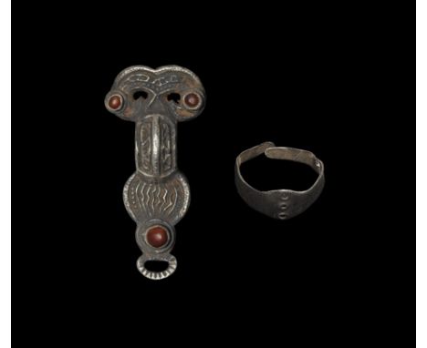  Early 6th century AD. A group of silver items comprising: a bow brooch with headplate formed as two addorsed bird-heads with