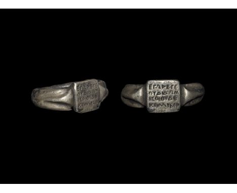  2nd-3rd century AD. A round-section silver hoop with expanding shoulders, median triangular raised rib, the plaque a square 