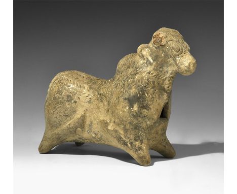  2nd millennium BC. A hollow-formed ceramic zebu bull figurine with legs extended, hair texture to the rump and forehead, rib