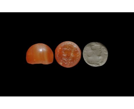  4th-6th century AD. A plano-convex carnelian stamp seal with intaglio profile male bust and headdress, text above; supplied 