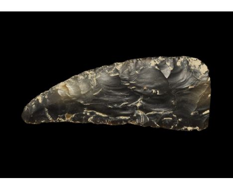  Neolithic, 5th-2nd millennium BC. The major portion of a knapped bifacial sickle knife in a grey-brown translucent flint, sh