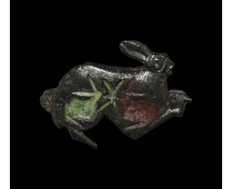  2nd century AD. A bronze brooch of a hare with panels of red and white enamel; pin to the back. 4 grams, 23mm (3/4"). Proper