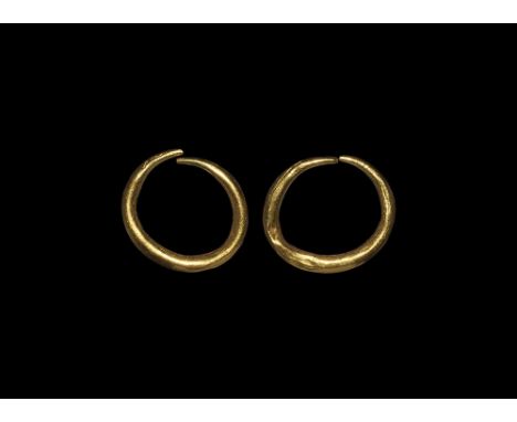  3rd century AD. A pair of hollow-formed gold penannular earrings each with an expanding hoop. Cf. Ruseva-Slokoska, L. Roman 