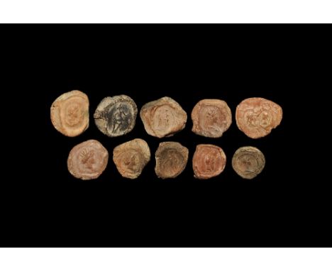  1st-3rd century AD. A mixed group of discoid ceramic theatre tokens or seals with impressed motifs from intaglio matrices, m