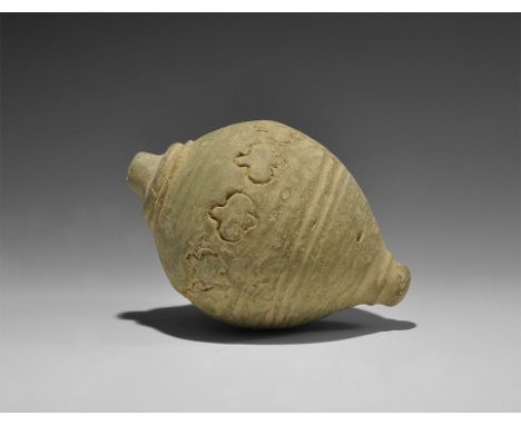  9th-11th century AD. A hollow-formed onion-shaped ceramic vessel with raised dome and central hole to the top, row of stampe