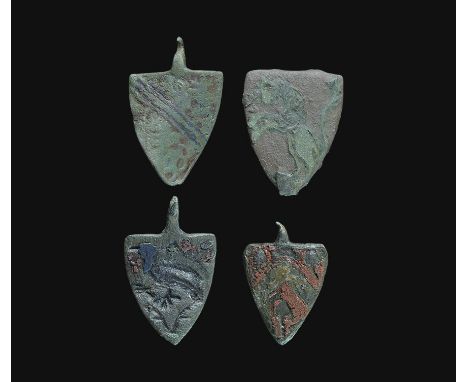  13th-14th century AD. A mixed group of heater-shaped pendants and plaques with enamelled heraldic ornament comprising: a pen