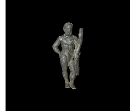  1st-2nd century AD. A bronze figure of Hercules standing with right hand on hip, naked but for a lion skin cloak over left a