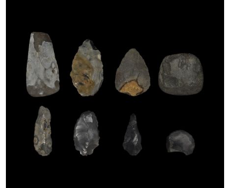  Palaeolithic to Neolithic, 600,000-3,000 years BP. A mixed group of stone implements comprising: a bifacial triangular handa