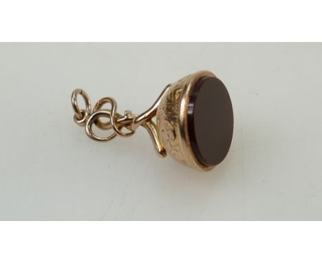 9ct rose gold ornate fob set with cornelian. 31mm height (excluding jump ring) x 18mm width.  Stamped 9ct twice.  6.7g gross 