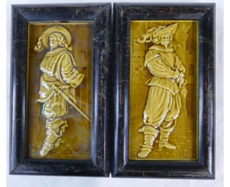 A pair of Minton China works rectangular tile panels each decorated with Cavaliers in straw glaze, both in wood frames (one b