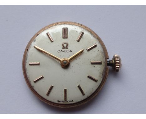 Hallmarked 18ct gold Omega ladies wrist watch on a rolled gold non Omega bracelet.  Mechanical movement caliber 620, winds, t