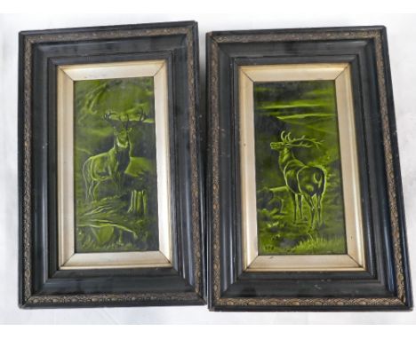 A pair of Sherwin &amp; Cotton rectangular tile panels each decorated with stags in green glaze, both in ebony frames (2)