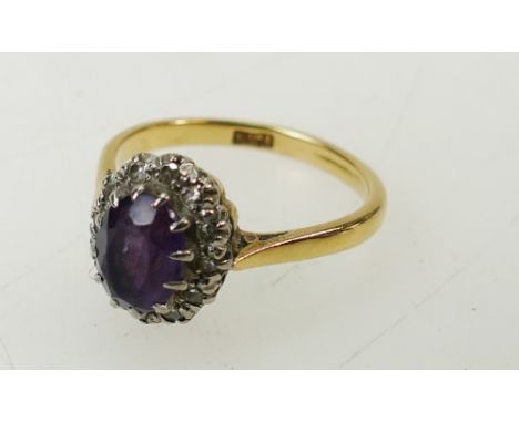 18ct gold ring set amethyst & 12 diamond cluster. Size N. Stone measures 8mm x 6mm.  Weight 3.7g.