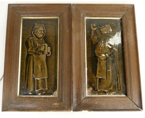A pair of oblong tile panels depicting drunken friars in brown glaze, 30cm x 14cm, tiles impressed England, both in wood fram