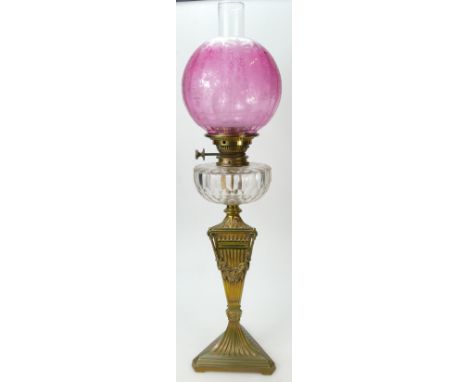 Victorian oil lamp with brass base and cranberry shade