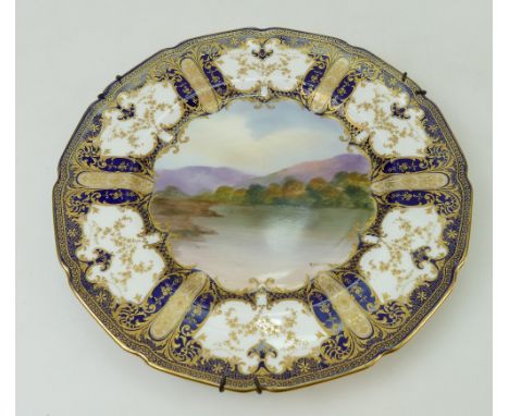 Royal Doulton gilded cabinet plate handpainted with lake and landscape scenes by R Brown, impressed date 1927