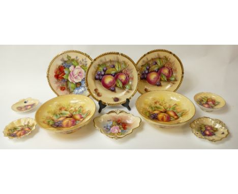 A collection of various Aynsley plates, footed bowls and dishes decorated in the Orchard Gold fruit design, signed by various