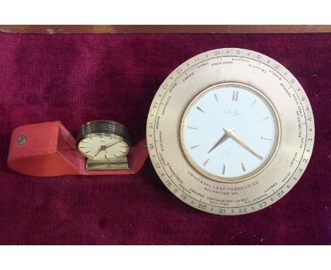 A Saint Blaise brass circular desk clock with movable outer ring numbered 1-24, with engraved names of cities on inner, engra